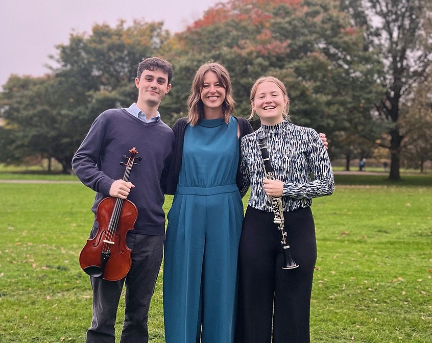 The three members of Cartref Chamber Collective with a viola and clarinet